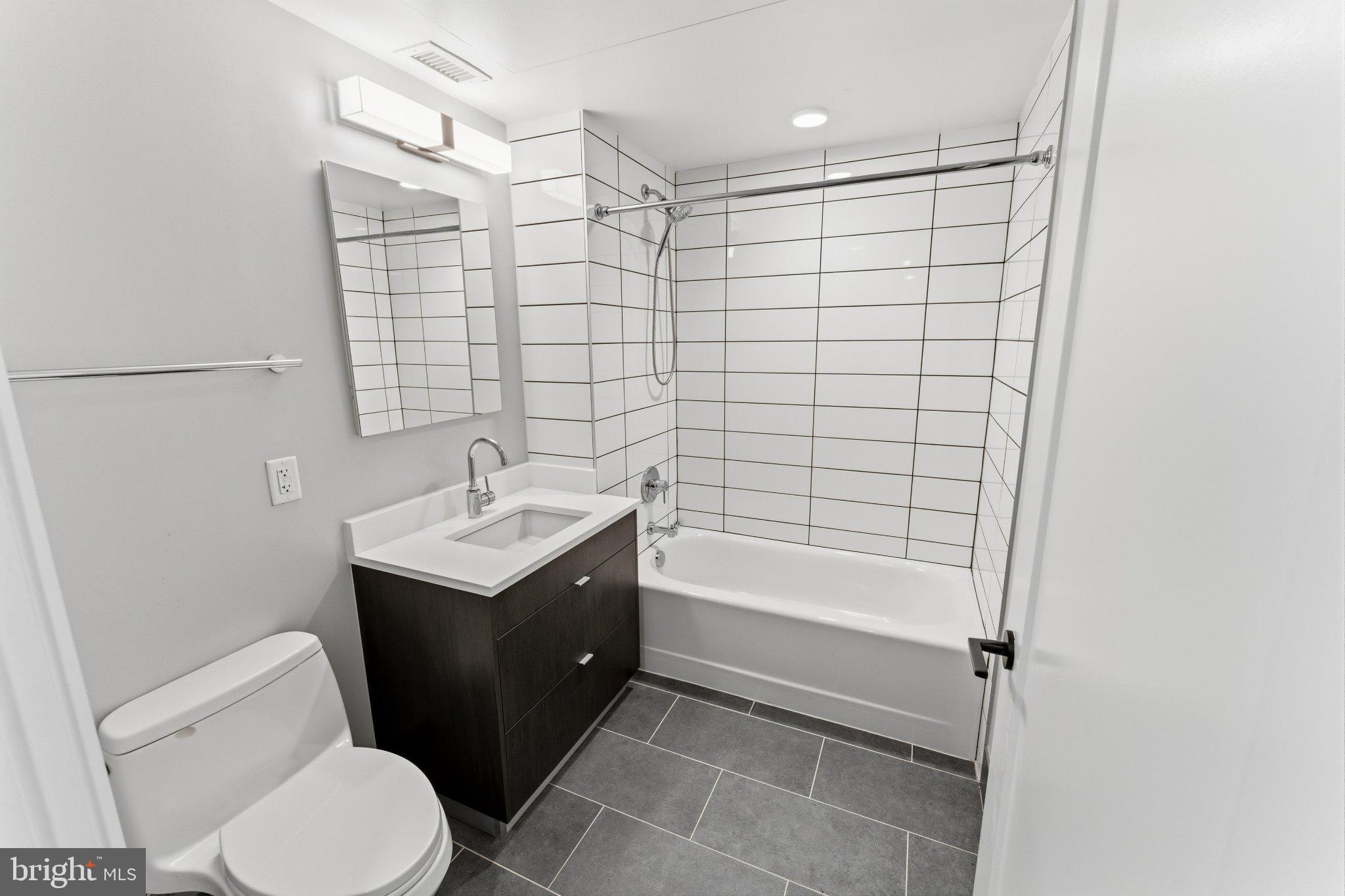 1300 4th Street Southeast, Unit 902 Washington, DC 20003 - Photo 6 of 42 a bathroom with a sink toilet and shower