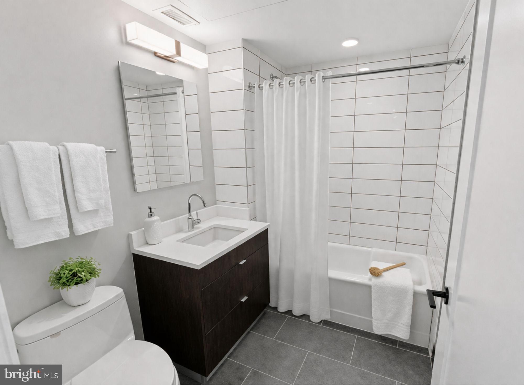 1300 4th Street Southeast, Unit 902 Washington, DC 20003 - Photo 7 of 42 a bathroom with a sink toilet and shower