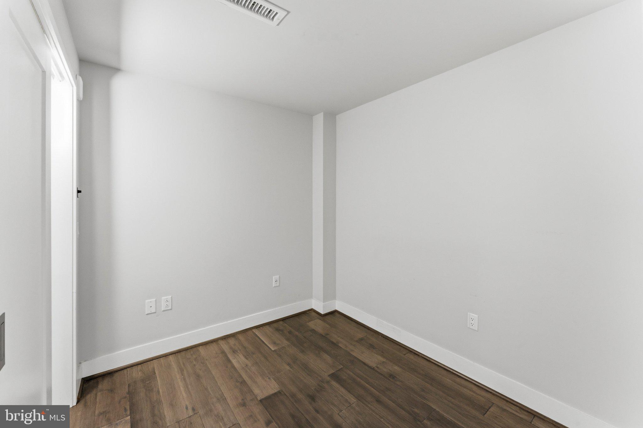 1300 4th Street Southeast, Unit 902 Washington, DC 20003 - Photo 9 of 42 a view of an empty room with wooden floor and a window
