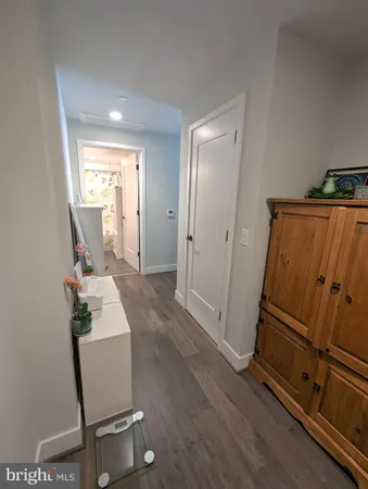 a view of a hallway with wooden floor and chair