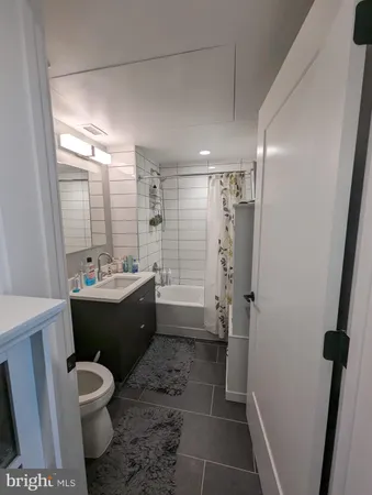 a bathroom with a double vanity sink toilet and shower