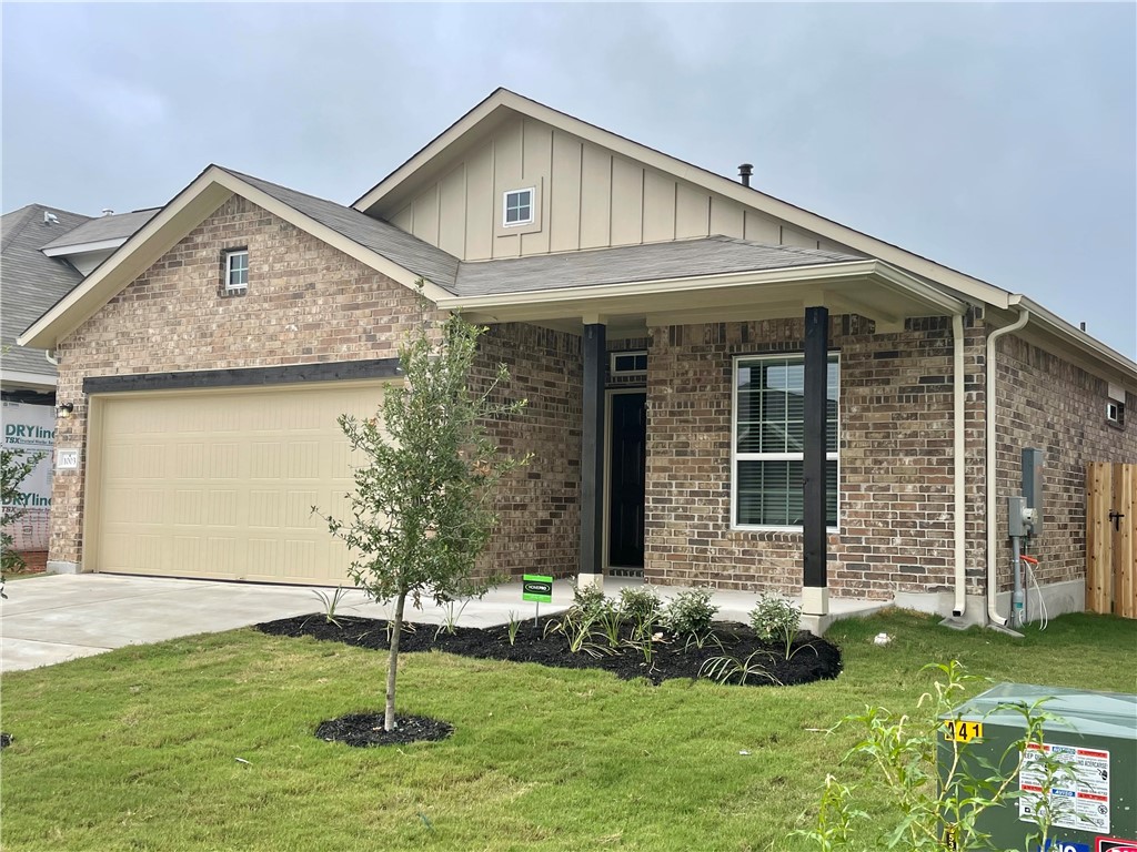 1003 Cherrystone Loop Buda, TX 78610 - Photo 1 of 27 a front view of a house with a yard