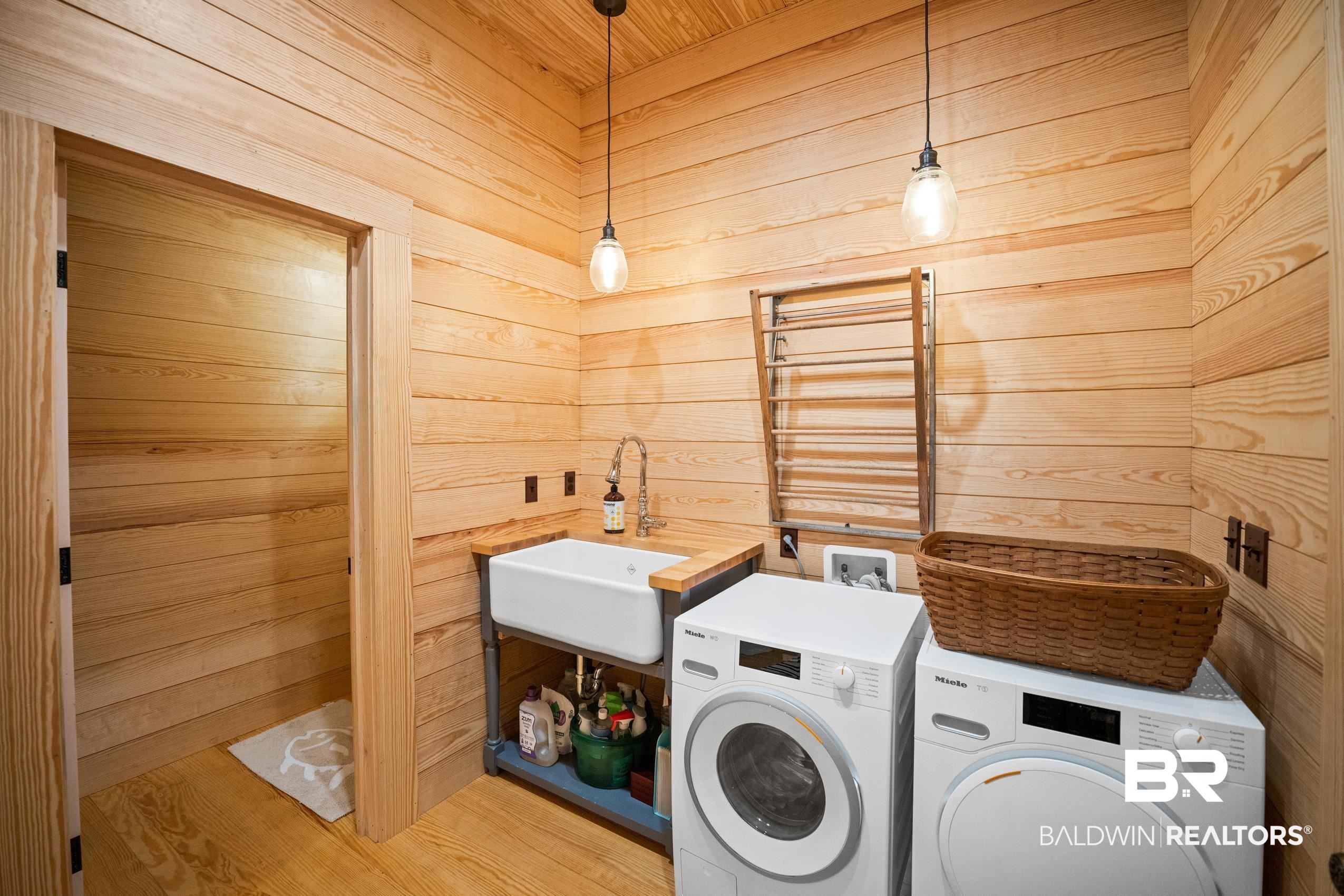30671 Magnolia Street Elberta, AL 36530 - Photo 49 of 68 Laundry room with a sink, independent washer and dryer, and wood walls