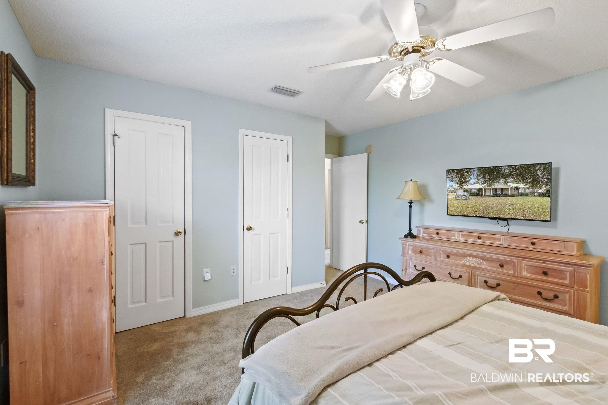14031 Brook Hollow Road Summerdale, AL 36580 - Photo 28 of 56 Bedroom with two closets, light colored carpet, and ceiling fan