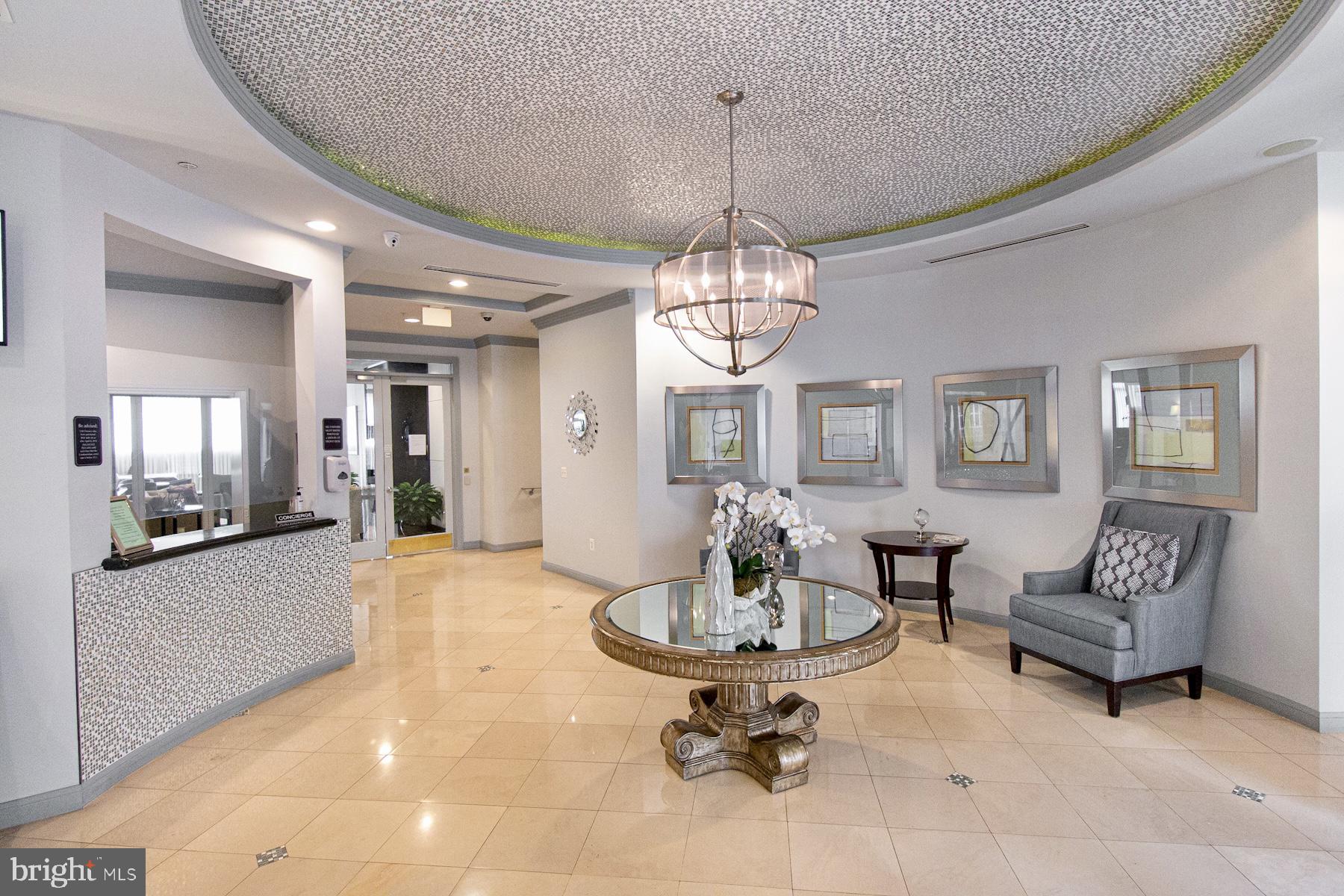 12001 Market Street, Unit 127 Reston, VA 20190 - Photo 19 of 27 Lobby with 24 hour security & Concierge services
