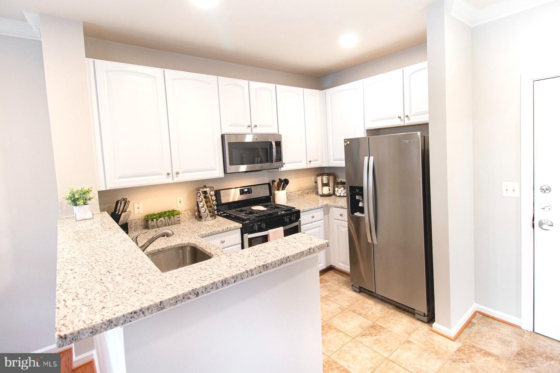 12001 Market Street, Unit 127 Reston, VA 20190 - Photo 6 of 27 Kitchen with granite and new stainless appliances