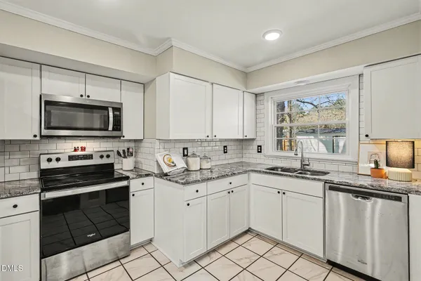 a kitchen with a sink stove and microwave