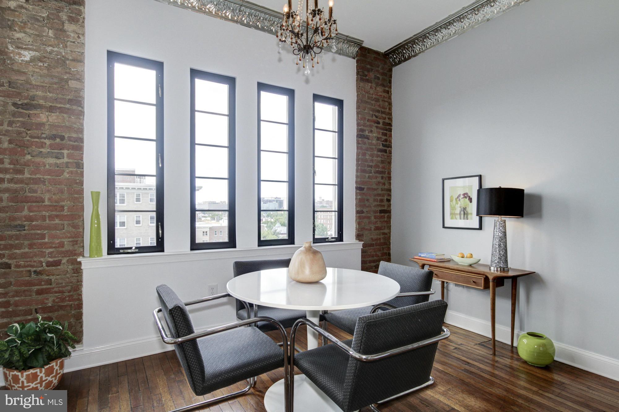 1701 16th Street Northwest, Unit 802 Washington, DC 20009 - Photo 4 of 11 a living room with furniture and a potted plant