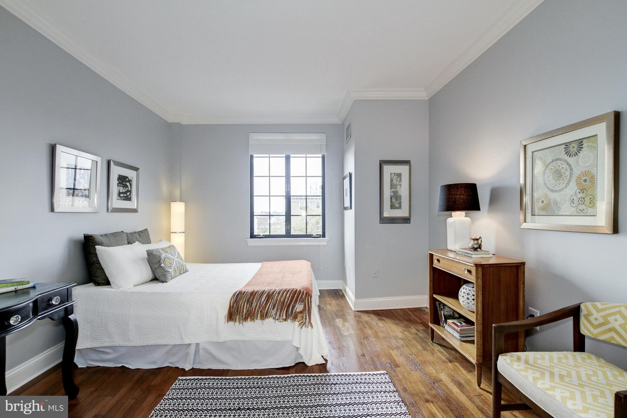 1701 16th Street Northwest, Unit 802 Washington, DC 20009 - Photo 6 of 11 a bedroom with a bed and wooden floor