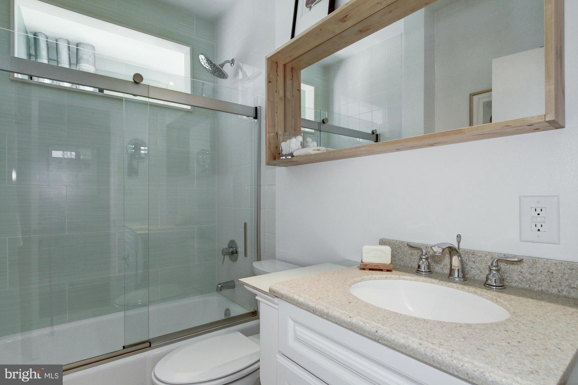 1701 16th Street Northwest, Unit 802 Washington, DC 20009 - Photo 7 of 11 a bathroom with a granite countertop sink toilet and shower