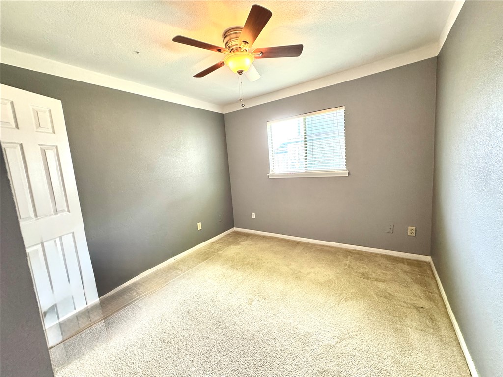6929 Monarch Street Corpus Christi, TX 78413 - Photo 12 of 16 an empty room with a window and a fan