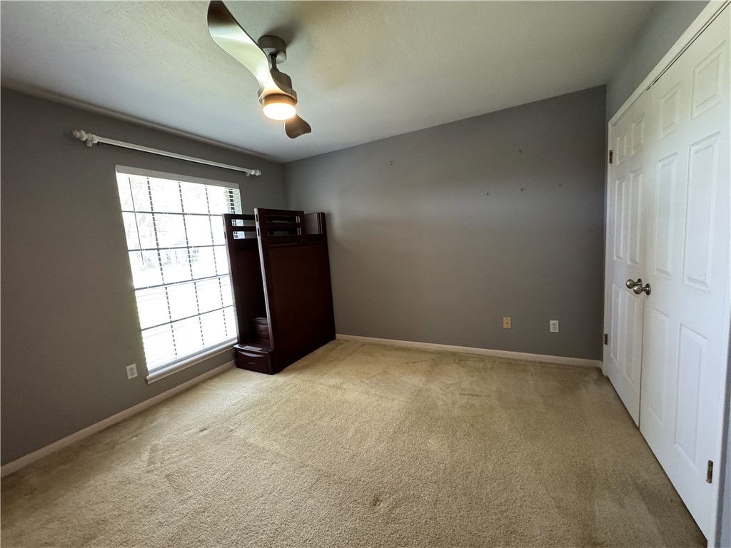6929 Monarch Street Corpus Christi, TX 78413 - Photo 13 of 16 en empty room with windows and ceiling fan