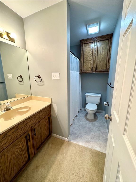 6929 Monarch Street Corpus Christi, TX 78413 - Photo 14 of 16 a spacious bathroom with a granite countertop sink a mirror and a toilet