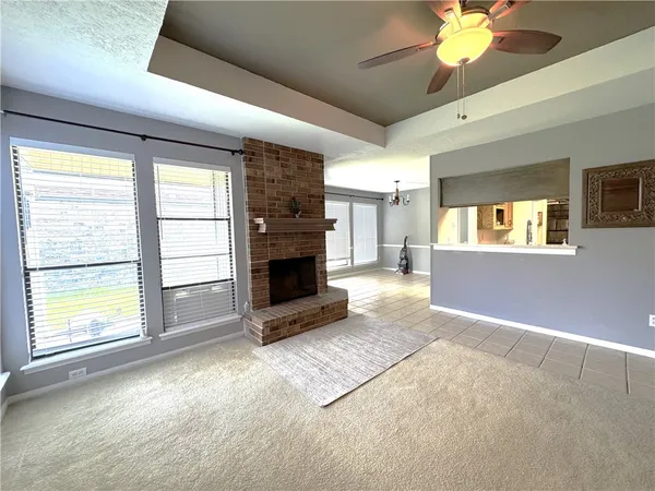 a view of a livingroom with a fireplace and window