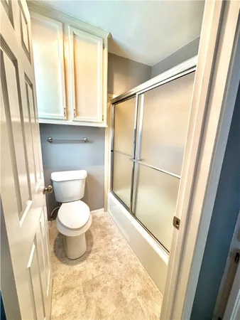 a bathroom with a toilet and a shower