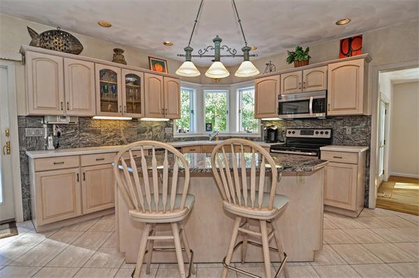 21 Lt J Cabral Drive Middleton, MA 01949 - Photo 12 of 30 a kitchen with stainless steel appliances granite countertop a stove a sink a microwave and a refrigerator