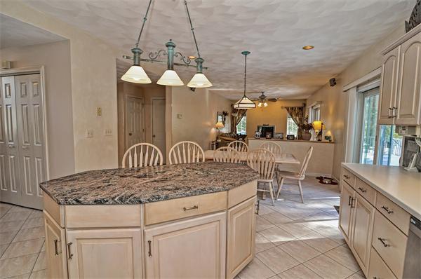 21 Lt J Cabral Drive Middleton, MA 01949 - Photo 16 of 30 a kitchen with a table chairs and white cabinets