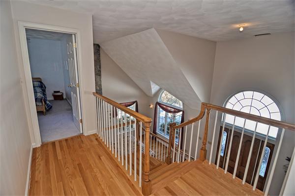 21 Lt J Cabral Drive Middleton, MA 01949 - Photo 17 of 30 a view of staircase with lots of frames on wall and wooden floor