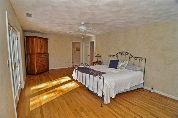 21 Lt J Cabral Drive Middleton, MA 01949 - Photo 23 of 30 a bedroom with a bed and a chandelier