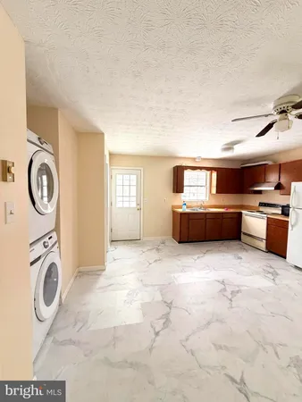 a view of kitchen sink and refrigerator