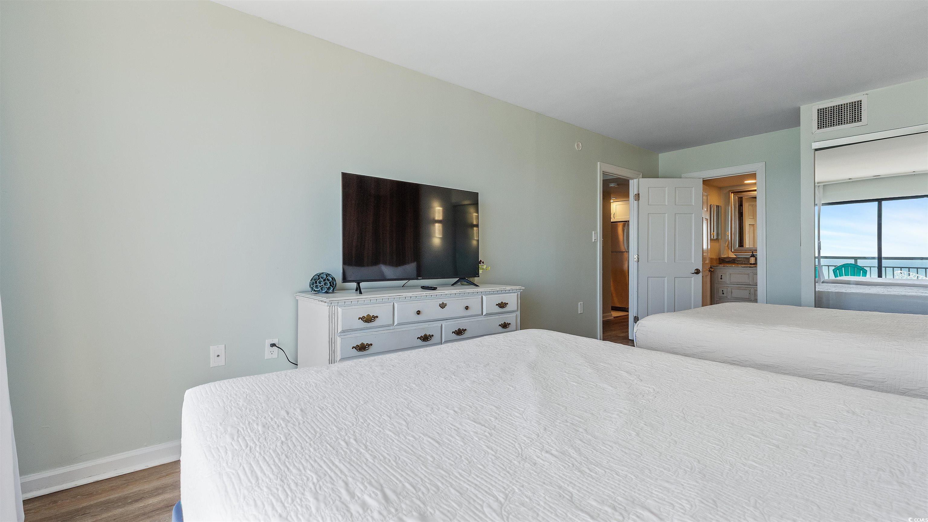 2001 South Ocean Boulevard, Unit 603 Myrtle Beach, SC 29577 - Photo 11 of 33 Bedroom with dark wood-type flooring and baseboards