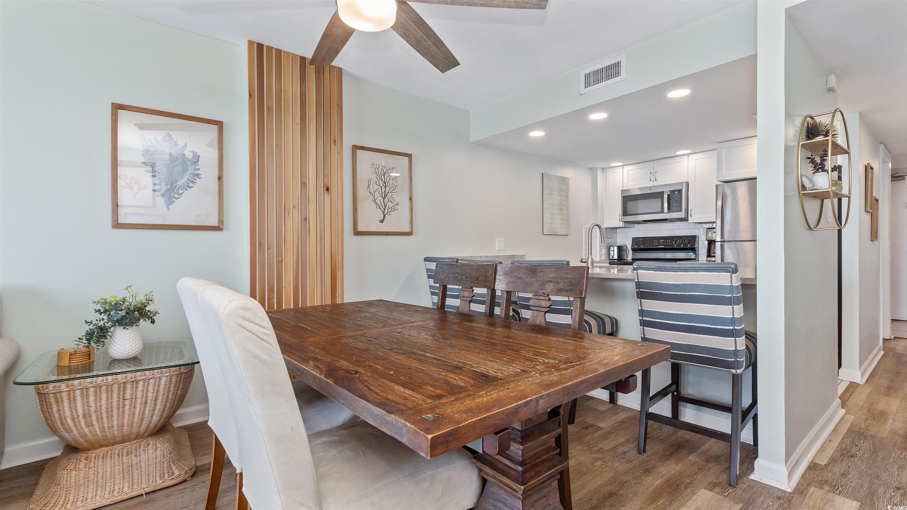 2001 South Ocean Boulevard, Unit 603 Myrtle Beach, SC 29577 - Photo 15 of 33 Dining area with recessed lighting, light wood-style flooring, and a ceiling fan
