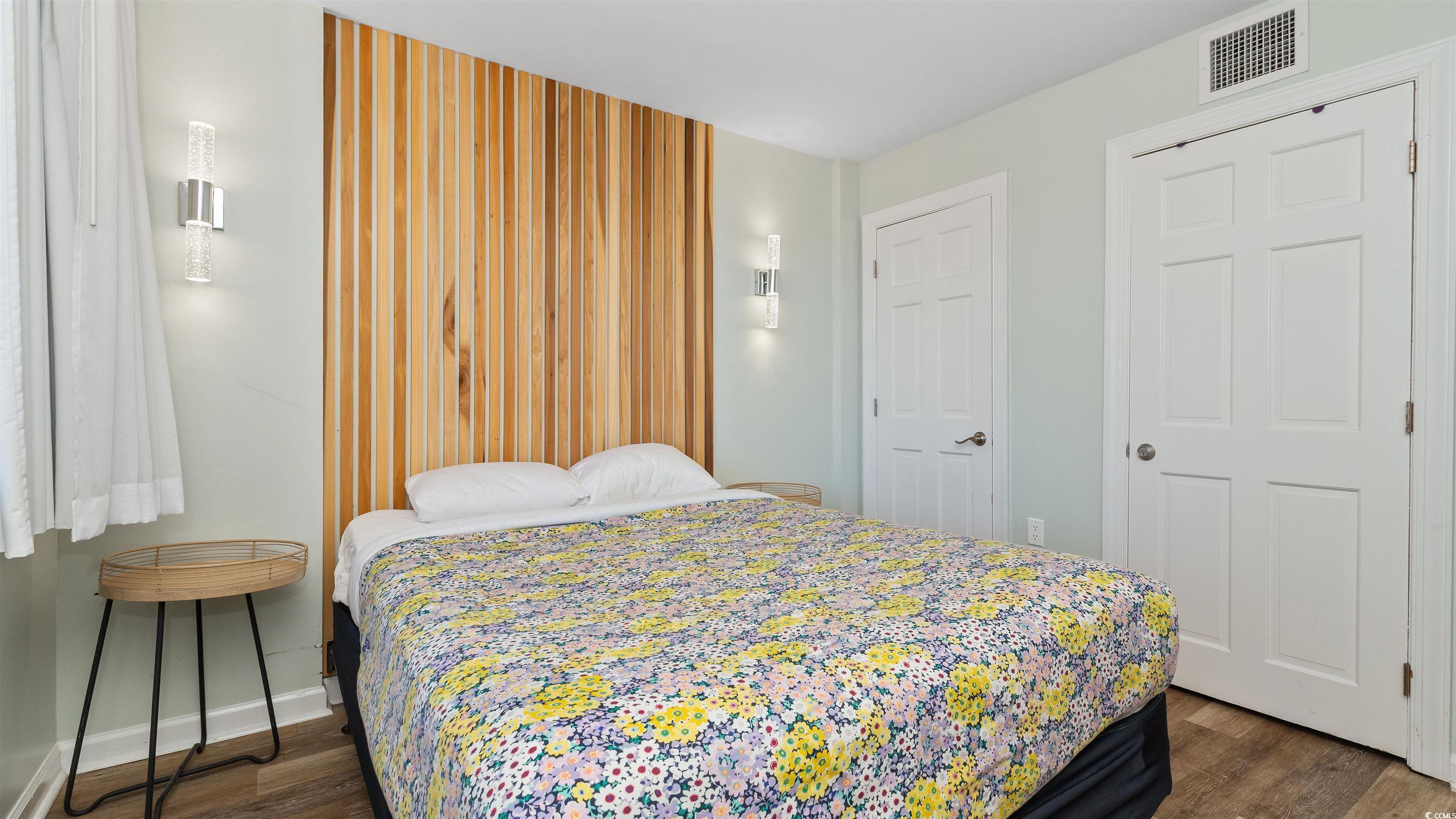 2001 South Ocean Boulevard, Unit 603 Myrtle Beach, SC 29577 - Photo 25 of 33 Bedroom with dark wood-style flooring and a closet