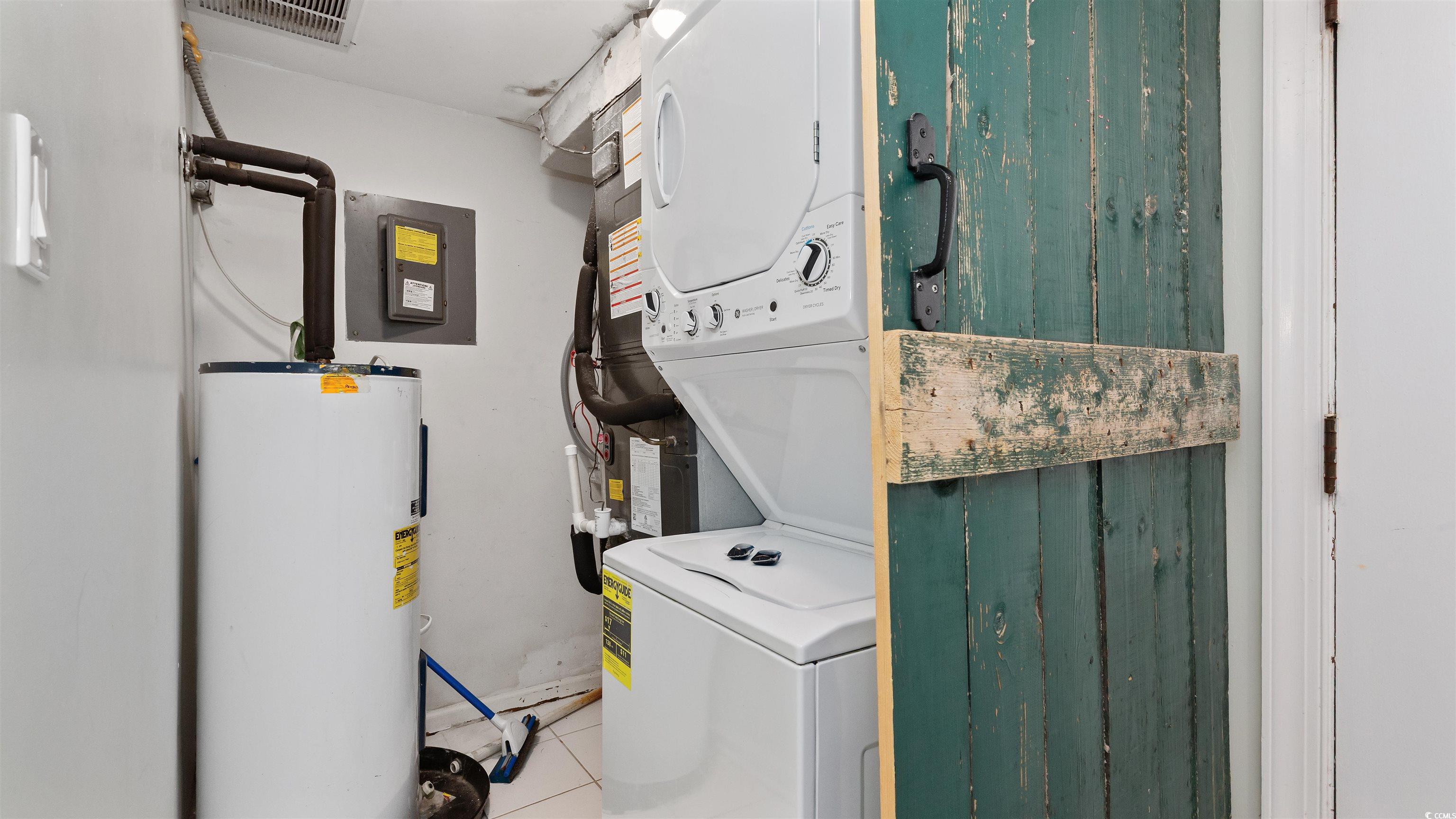 2001 South Ocean Boulevard, Unit 603 Myrtle Beach, SC 29577 - Photo 29 of 33 Washroom with water heater, estacked washer and dryer, tile patterned flooring, and electric panel