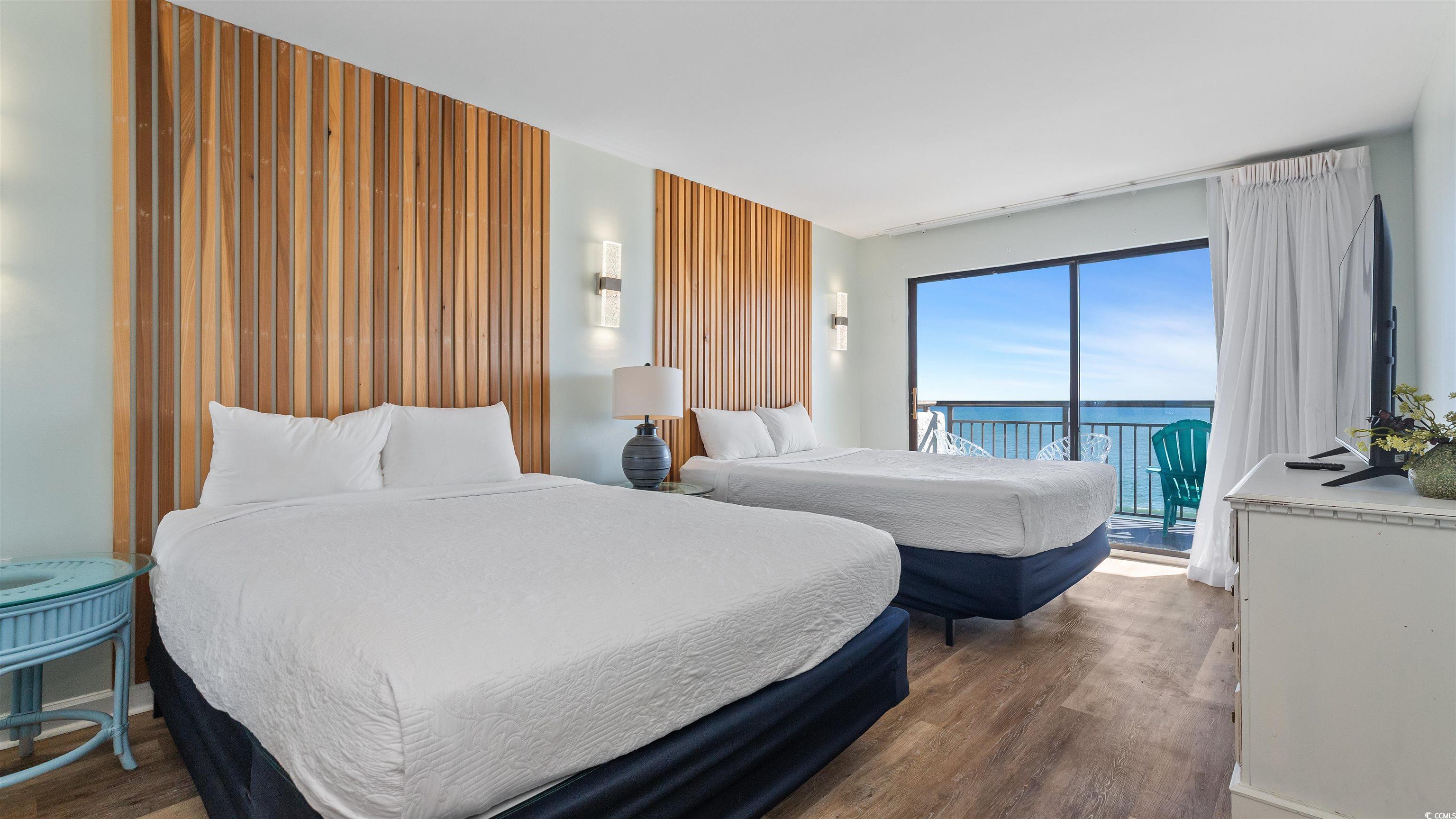 2001 South Ocean Boulevard, Unit 603 Myrtle Beach, SC 29577 - Photo 3 of 33 Bedroom featuring wood finished floors and access to outside