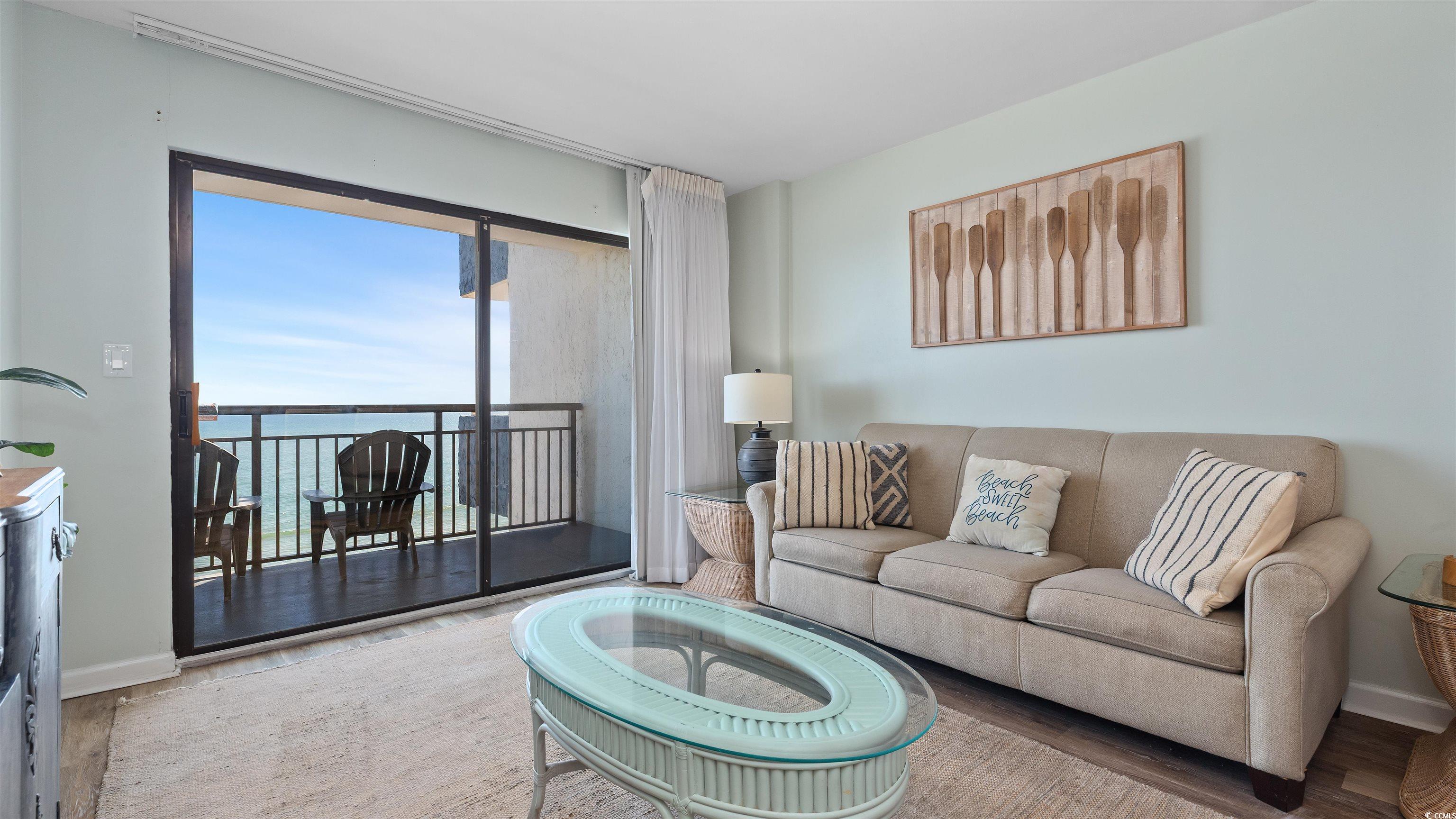 2001 South Ocean Boulevard, Unit 603 Myrtle Beach, SC 29577 - Photo 4 of 33 Living room featuring wood finished floors and a water view