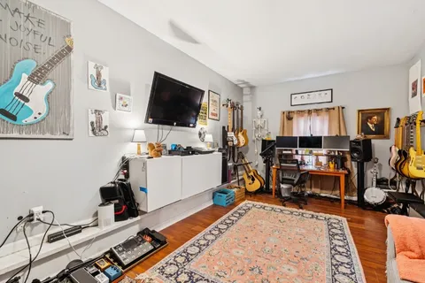 a bed room with furniture and a flat screen tv