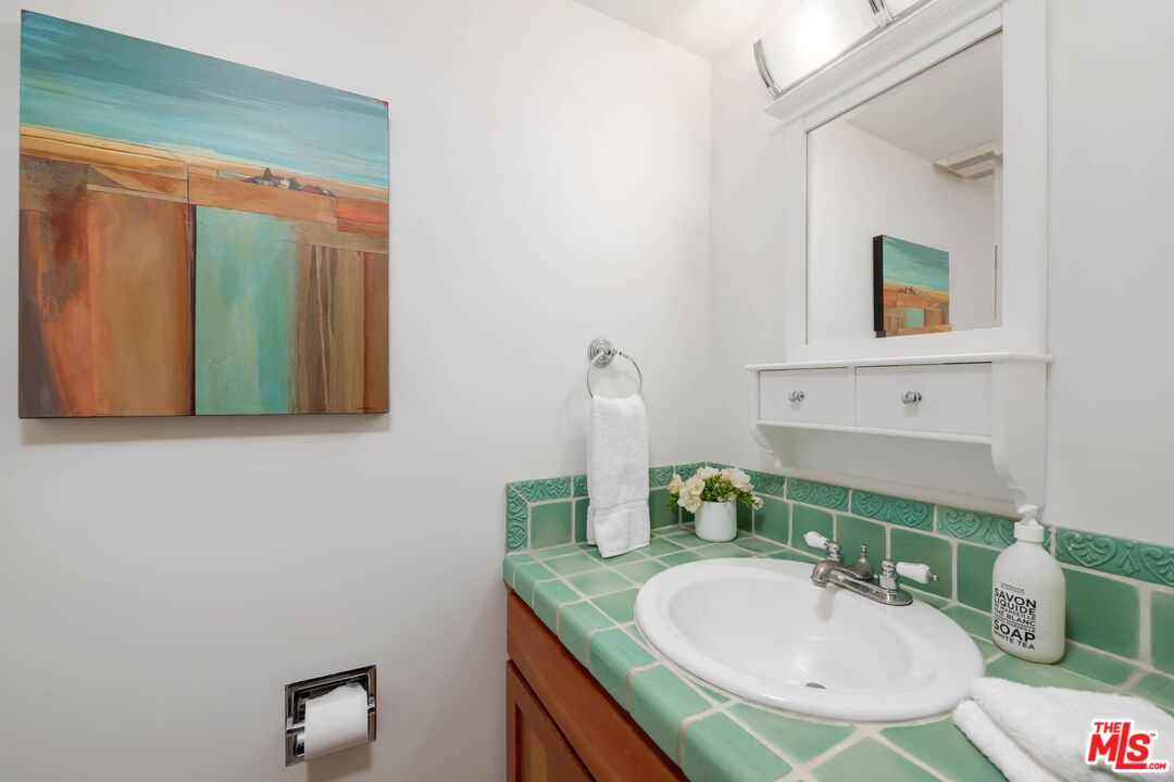 355 Sycamore Road Santa Monica, CA 90402 - Photo 1 of 1 a bathroom with a sink and a mirror