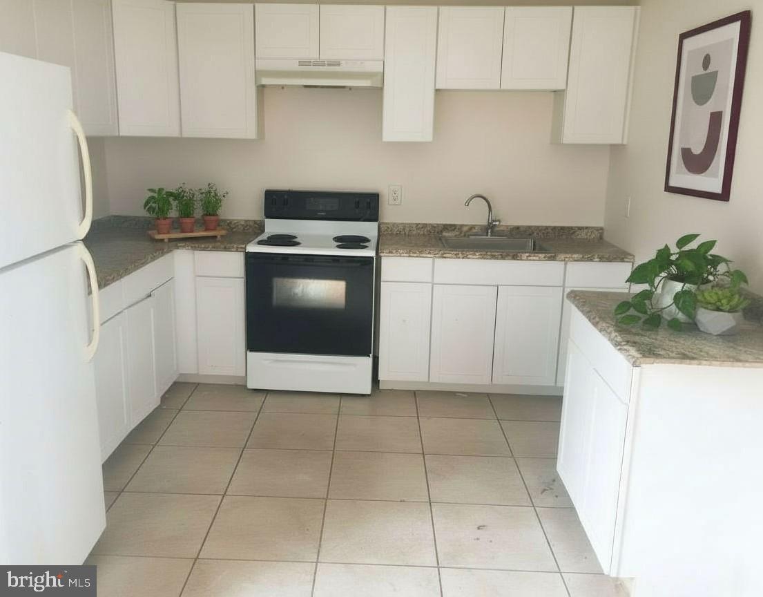 46842 Patuxent Road Lexington Park, MD 20653 - Photo 2 of 4 a kitchen with a sink a stove and cabinets