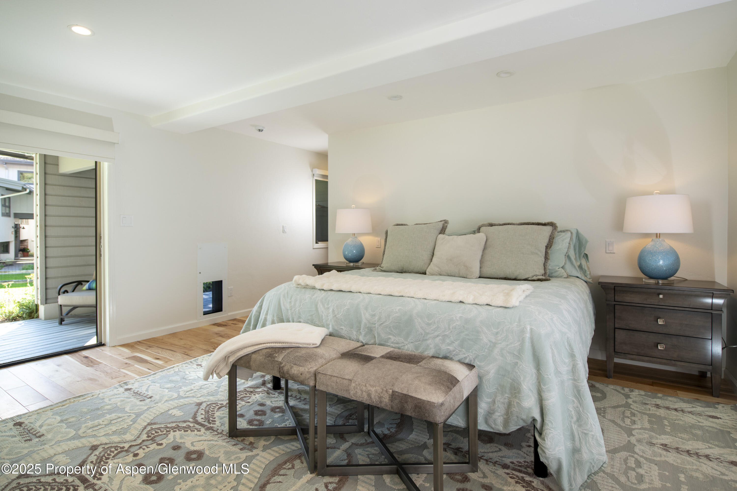 1417 Sierra Vista Drive Aspen, CO 81611 - Photo 14 of 37 a bedroom with a bed and wooden floor