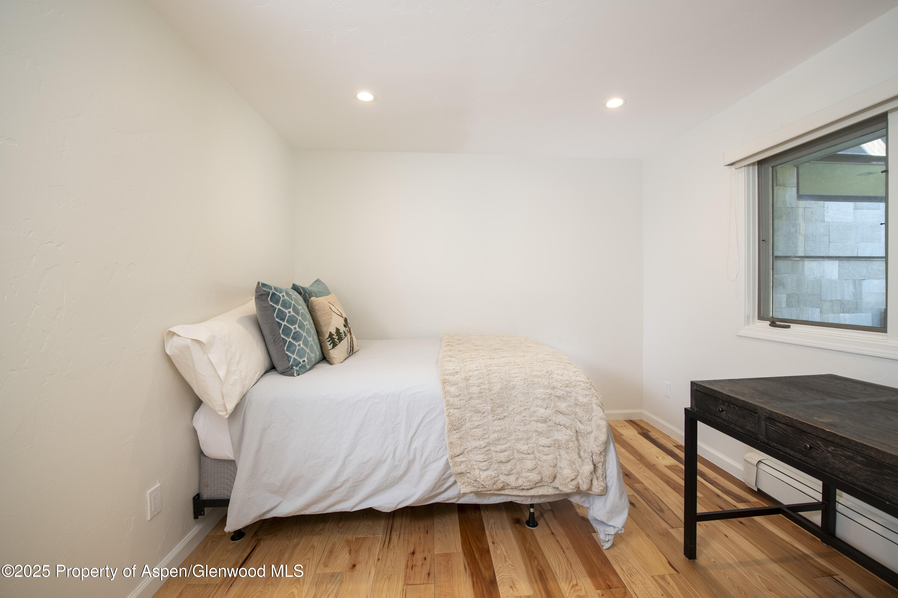 1417 Sierra Vista Drive Aspen, CO 81611 - Photo 19 of 37 a bedroom with a bed and a table