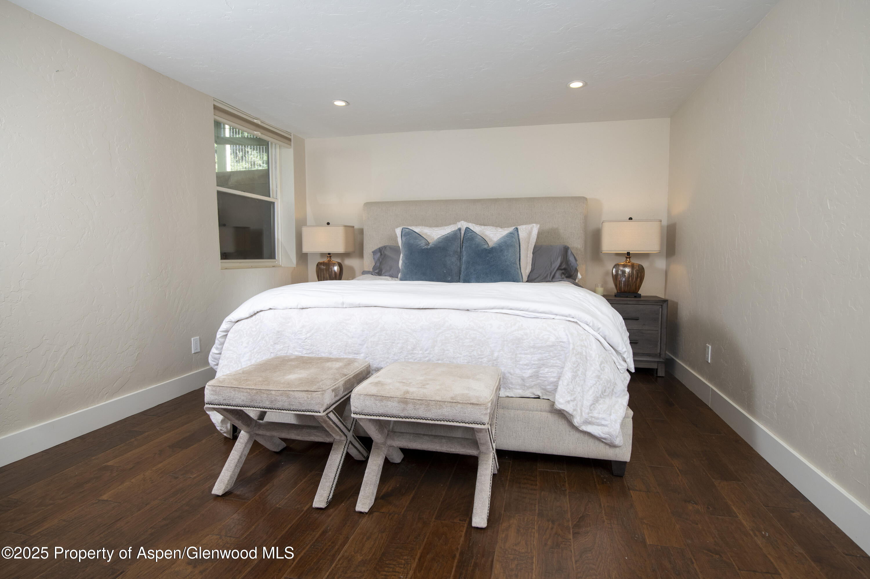 1417 Sierra Vista Drive Aspen, CO 81611 - Photo 21 of 37 a bedroom with a bed a table and chair