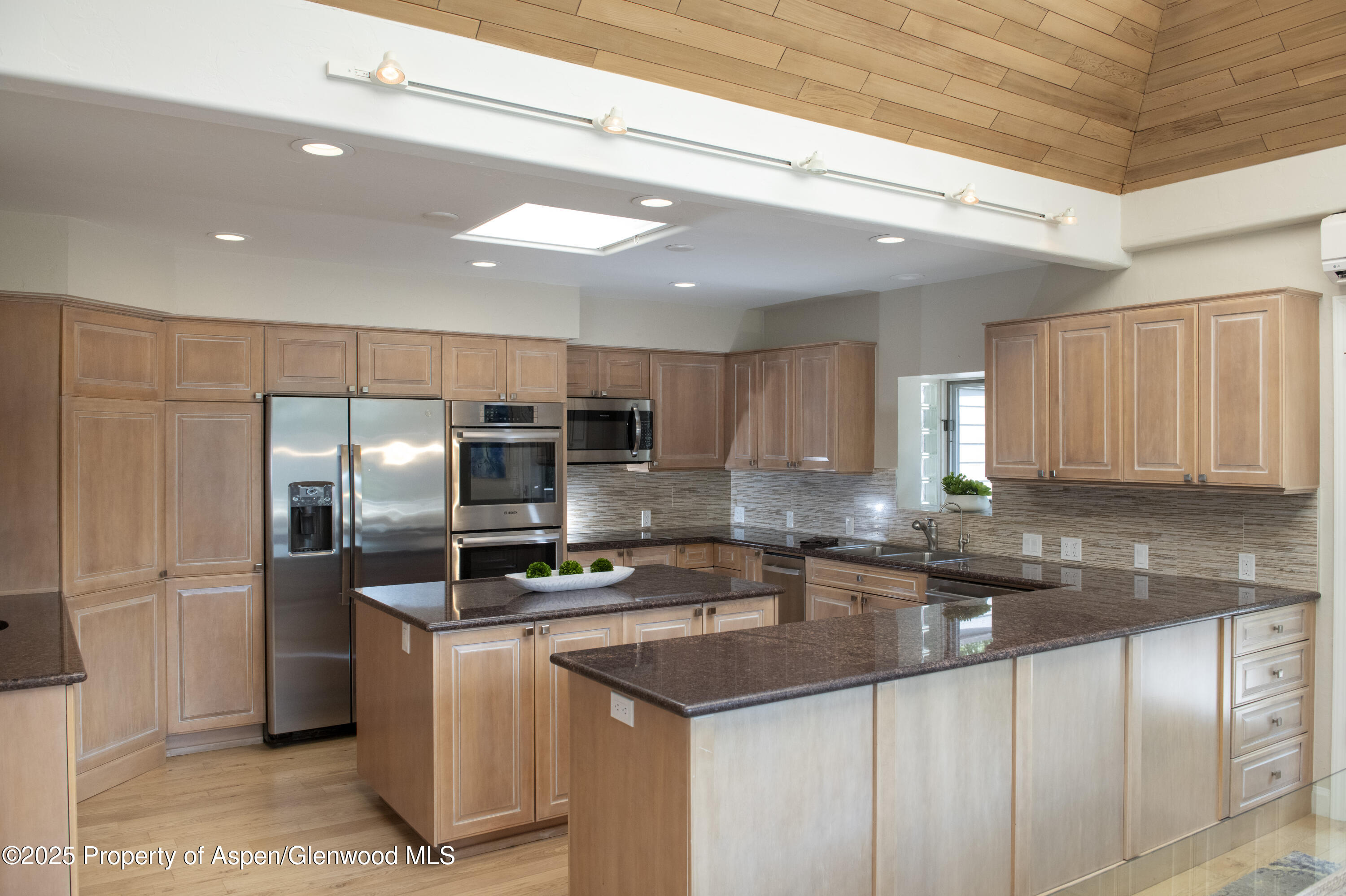 1417 Sierra Vista Drive Aspen, CO 81611 - Photo 7 of 37 a kitchen with kitchen island granite countertop a sink stainless steel appliances and cabinets
