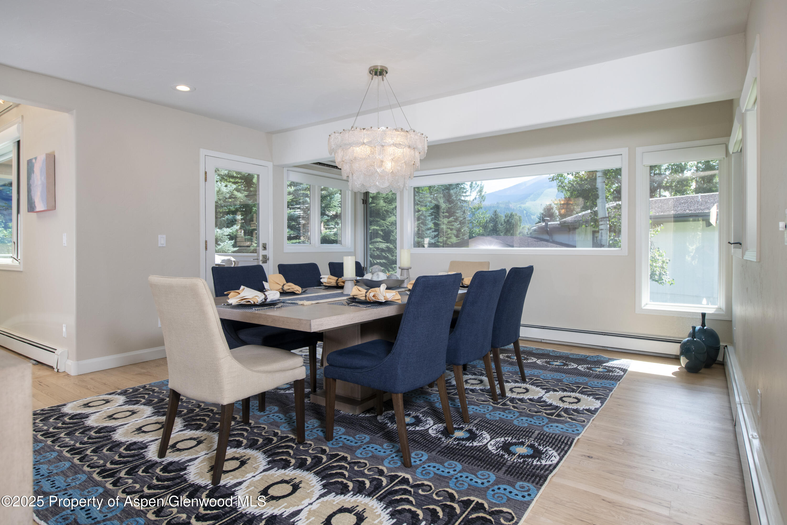 1417 Sierra Vista Drive Aspen, CO 81611 - Photo 9 of 37 a view of a dining room with furniture wooden floor and chandelier
