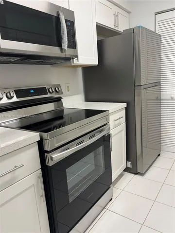 a kitchen with appliances and cabinets