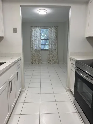 a kitchen with a sink a stove and cabinets