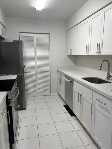 a kitchen with a sink cabinets and utility