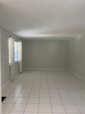 an empty room with white walls