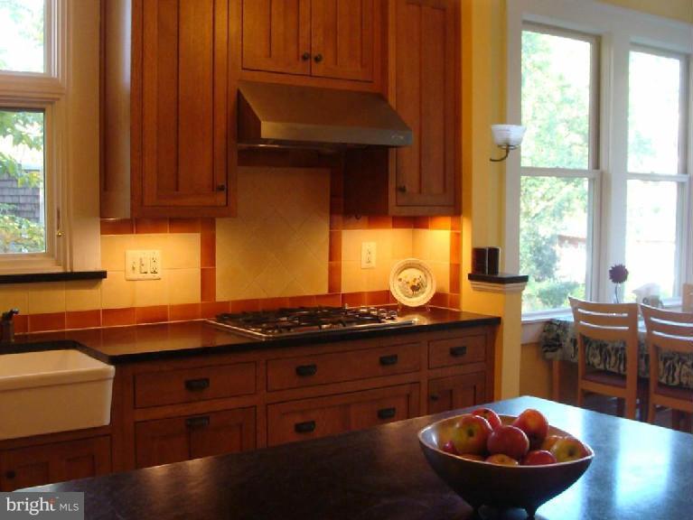 5717 Uffington Road Baltimore, MD 21209 - Photo 7 of 19 a kitchen with a sink and wooden cabinets