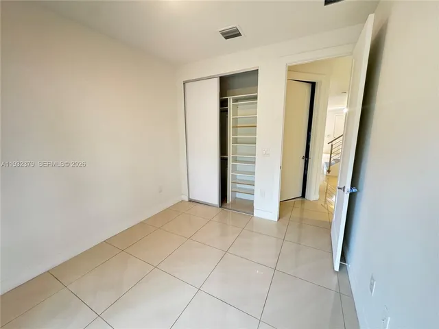 a view of empty room with large windows