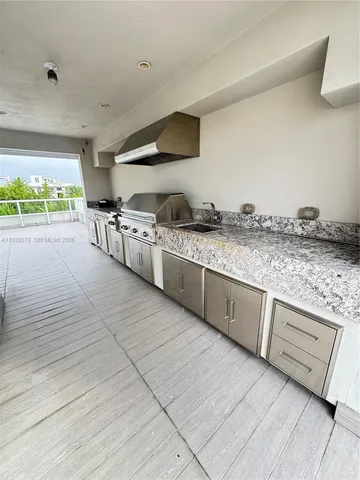 a kitchen with stainless steel appliances granite countertop a stove and a sink