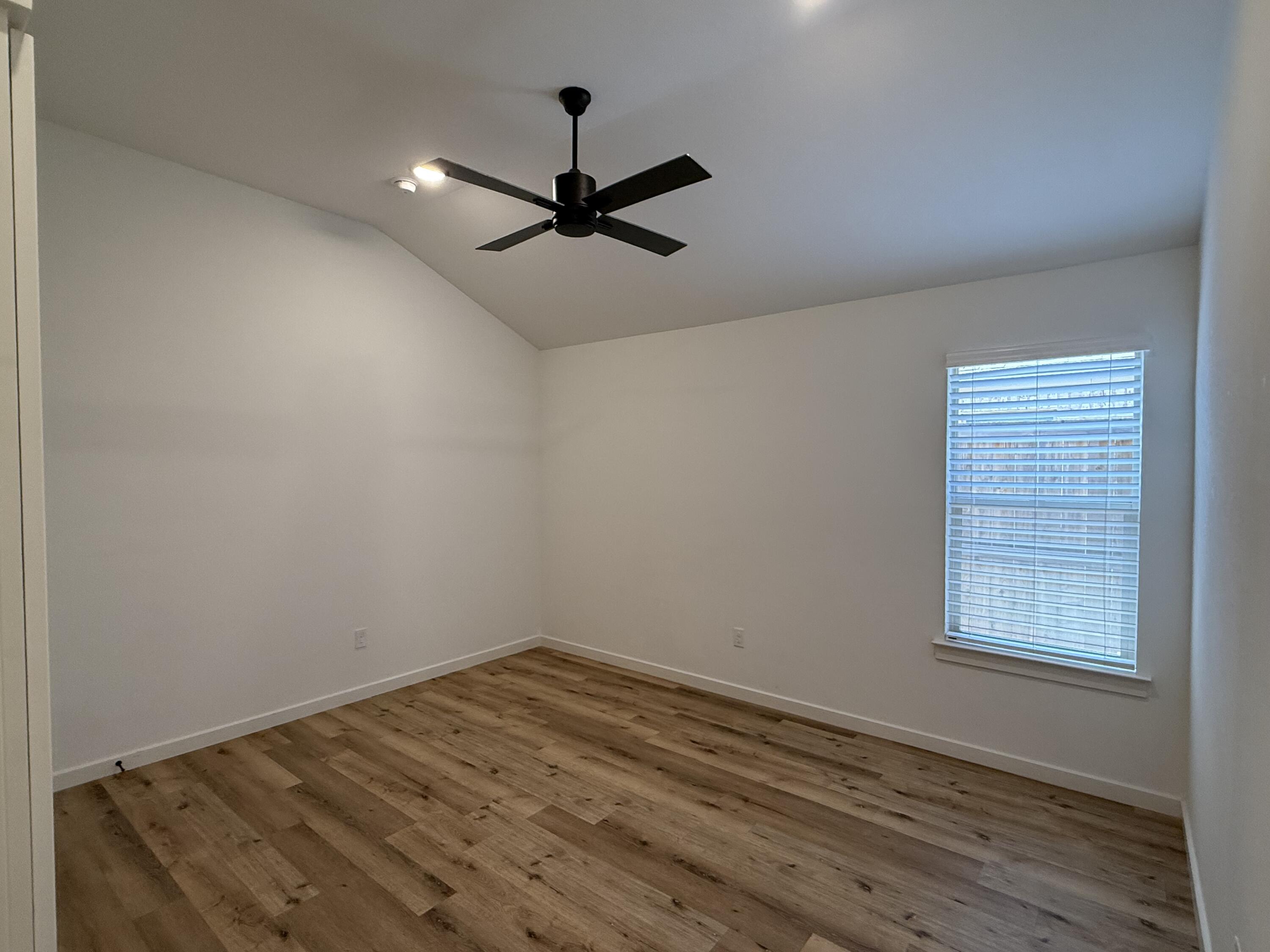 3605 128th Street Lubbock, TX 79423 - Photo 16 of 23 an empty room with a window and a ceiling fan
