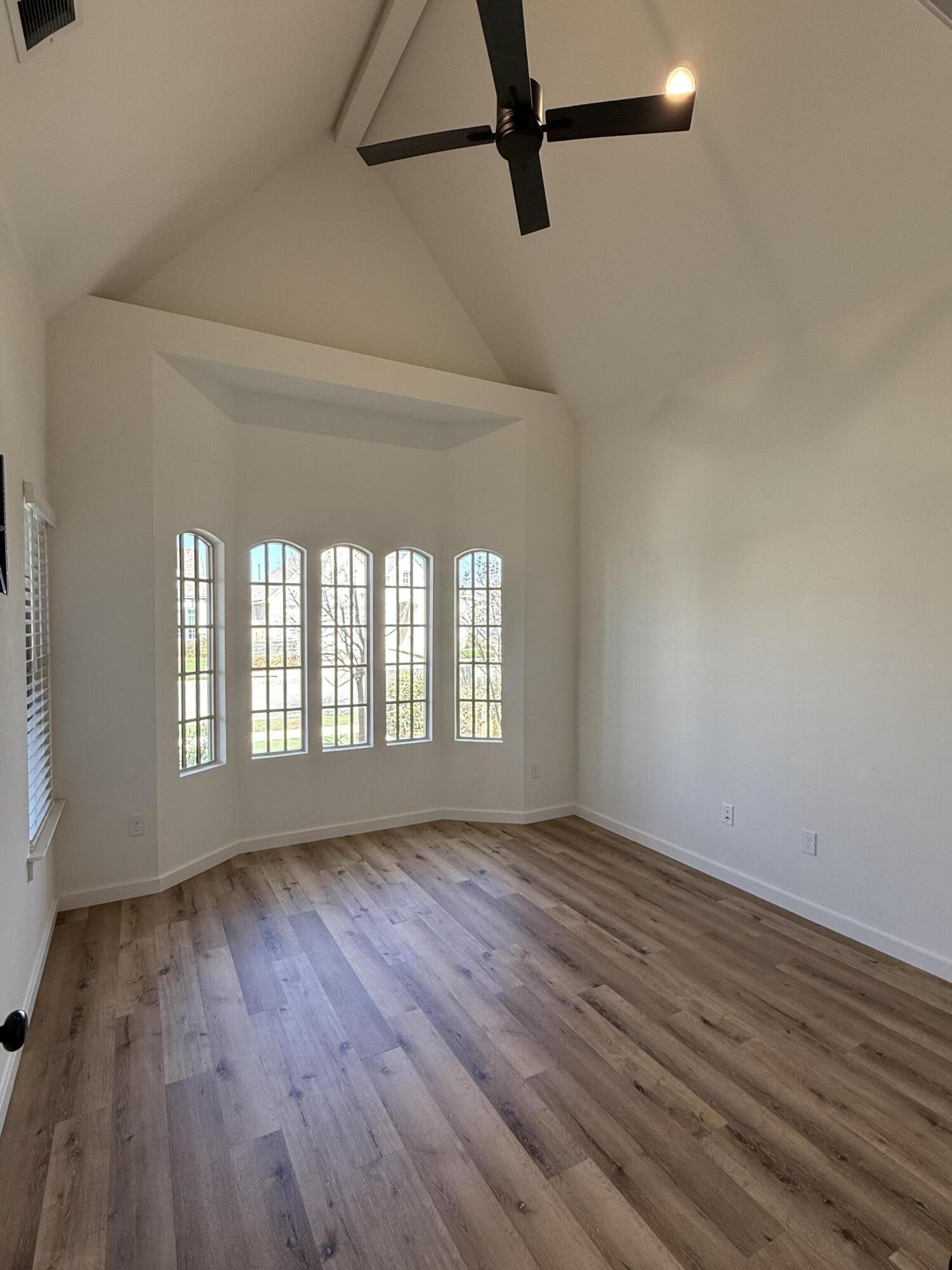 3605 128th Street Lubbock, TX 79423 - Photo 17 of 23 a view of an empty room with wooden floor and a window