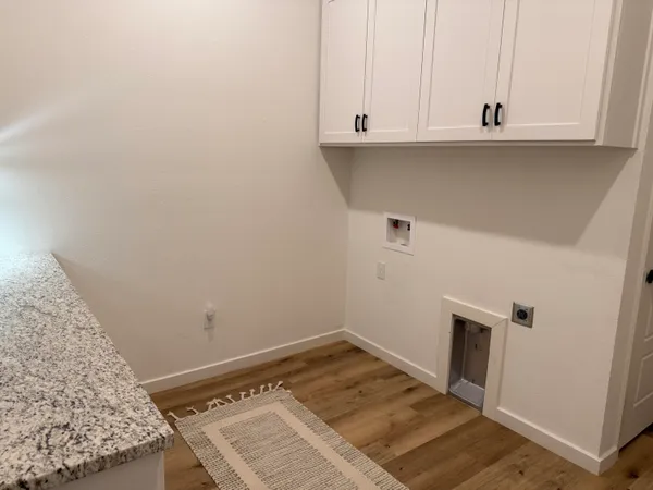 a view of a room with wooden floor and cabinet