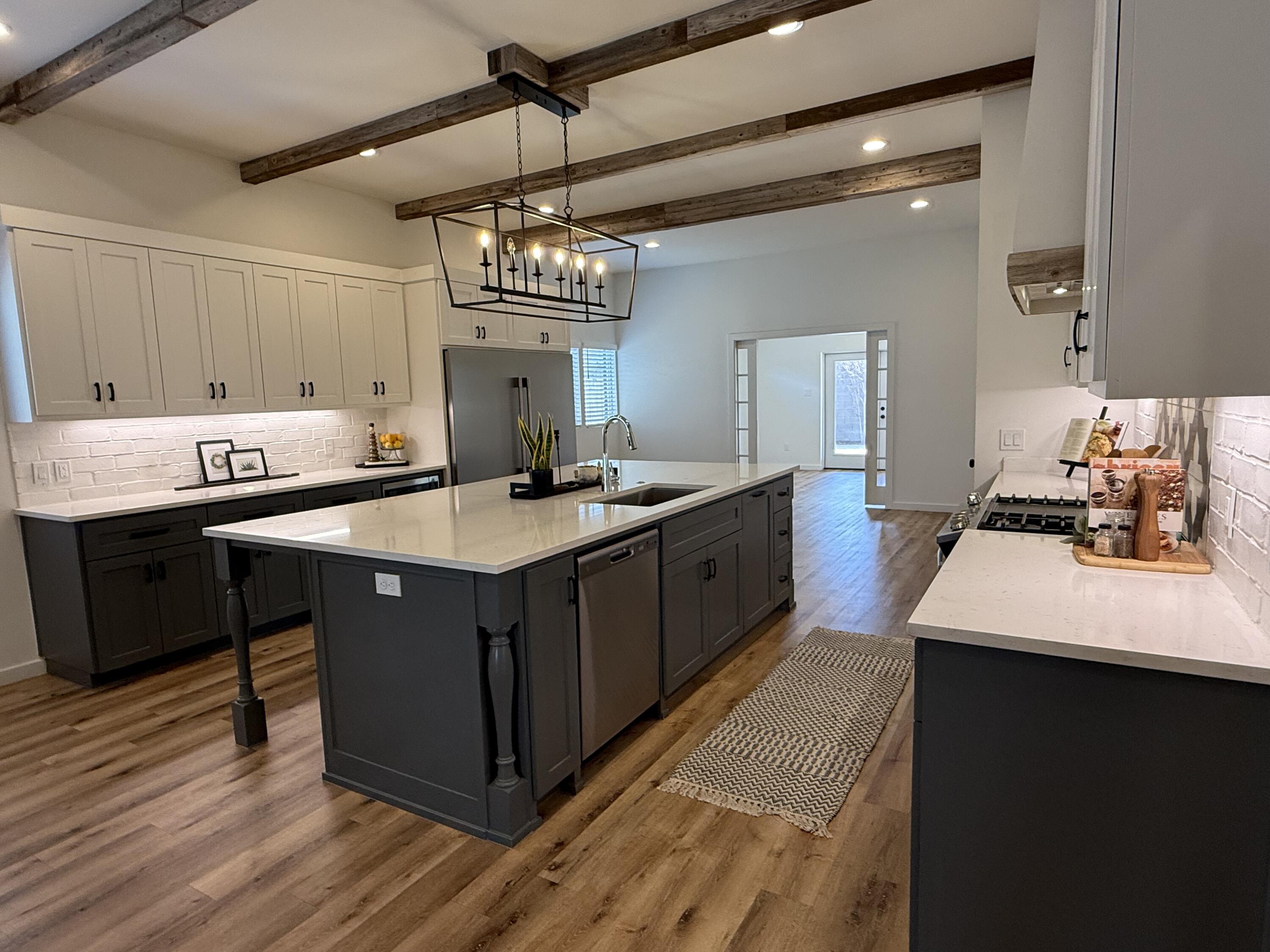 3605 128th Street Lubbock, TX 79423 - Photo 4 of 23 a kitchen with a sink a counter space and wooden floor