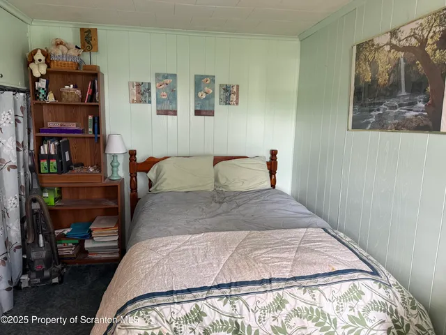 a bedroom with a bed a baby and a bookshelf
